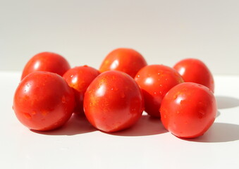 Red natural tomatoes isolated on white background.
