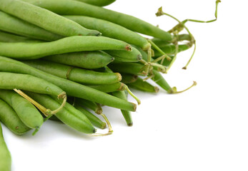 small and slender green beans (haricot vert) on a white background