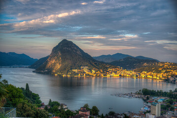 Early view of the lake of Lugano in Ticino, Switzerland. Sunrise during summer