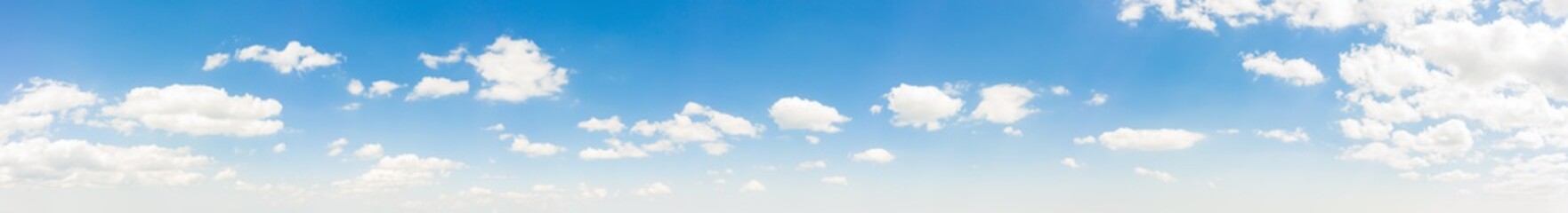 Summer sky background with warm and soft sunny tonings. Wide angle panorama for design works