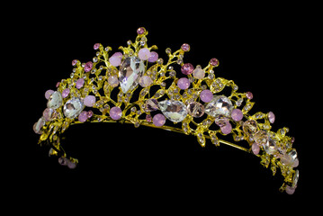 Jewelry gold crown tiara with diamonds and gemstones on black background © axivan.com