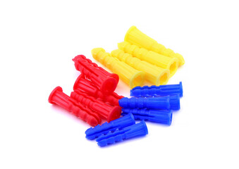 Set of colorful dowels, wall plugs isolated on a white background. Dowels, wall plugs