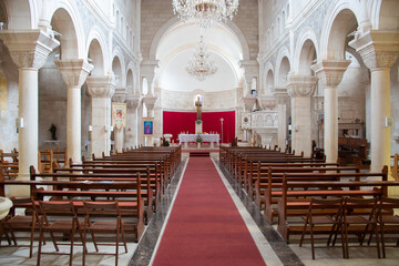 Fototapeta premium Selca Croatia August 2020 Interior of the famous big church in the village of selca on the island of brac. Red carpet leading to the altar and benches