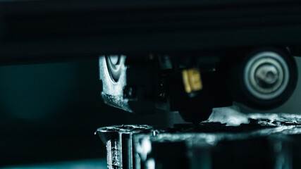 3D printer working in a factory printing plastic part.