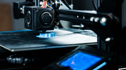 Fototapeta na wymiar 3D printer working in a factory printing plastic part.