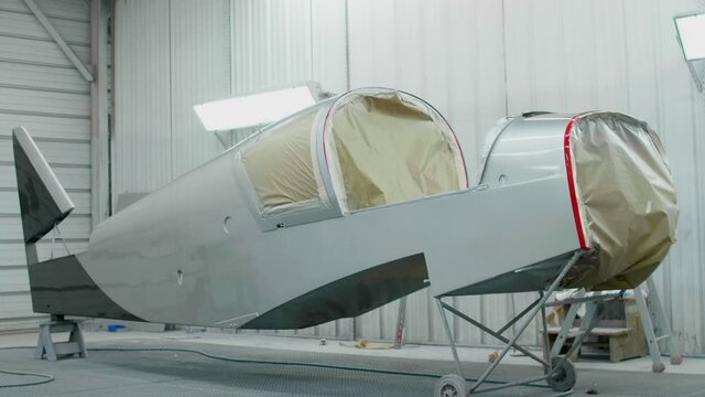 Aircraft fuselage in a paint shop, slowmotion