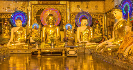A room of golden Buddhas at the Shwedagon Pagoda, Yangon, Myanmar