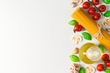 Set of products for cooking Italian pasta with mushrooms on a light gray background. Flat lay with place for text.