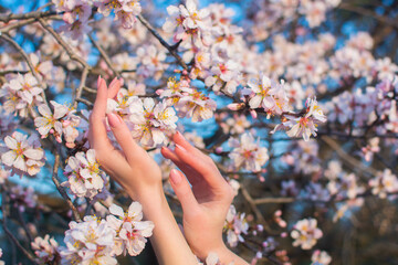 Girl's hands on a background of flowers