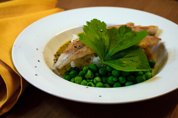 grilled fish fillet on rice with yellow napkin on wooden table