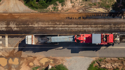 Top view, Dump truck and Road milling machine working demolish surface asphalt road old for repairing. © ME Image