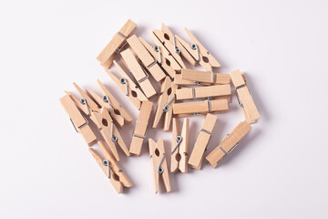 Wooden paper clip on white background.