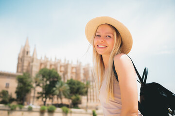 Adventure time - Attractive caucasian smiling girl tourist in hat exploring new city at summer
