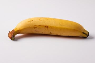One banana on a white background. Copy space.