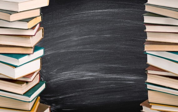 Stack of books, education and learning background with a blackboard