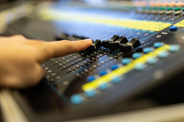 Sound recording studio mixing desk with engineer or music producer  with side view selective focus.