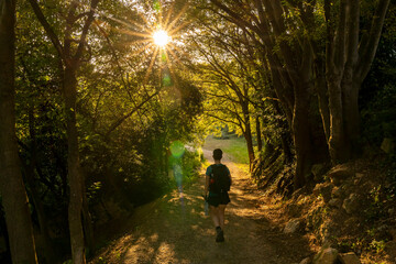 Fototapeta na wymiar Treekking at dawn leaving Girona with a hiker on the way.