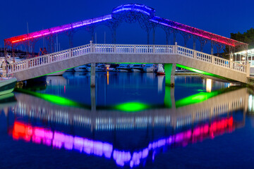 Illuminated bridge in the evening in The Rogoznica village, a popular tourist destination on the Dalmatian coast of Adriatic sea in Croatia, Europe.