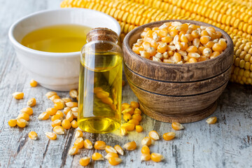 Corn essential oil bottle, corn groats, dry seeds and corncobs 