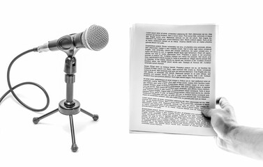 Hand holds a sheet of paper with text and microphone