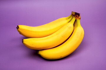 bunch of bananas on a purple background