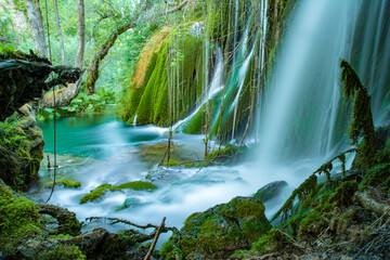 Volturno river waterfalls, scenic view in summer with green moss, Molise region, Italy