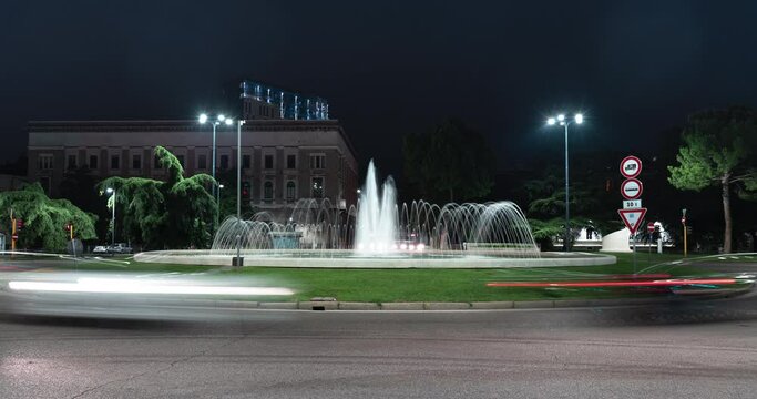 Timelapse view of the traffic on the square around the fountain. Urban roundabout in the Italian city of Brescia. Time Lapse.