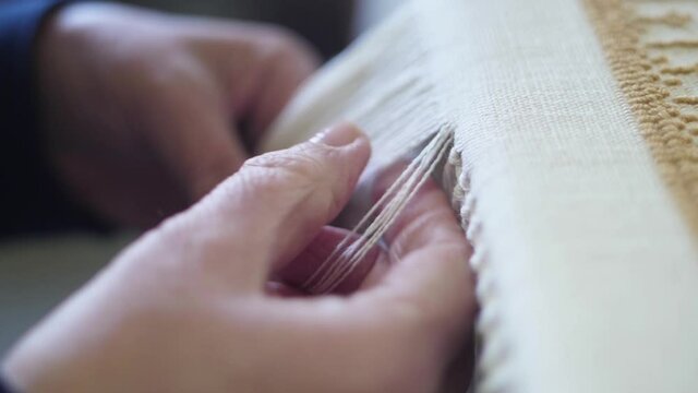 making traditional tapestry on a wooden weaving loom slow motion