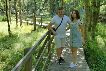 Boyfriend and girlfriend. Couple. In love. Forest Arboretum in Kudypy. Poland - Masuria - Warmia....