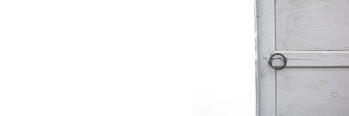 Header with white copy space and old grey painted door with forged antique roung handle, aspect...