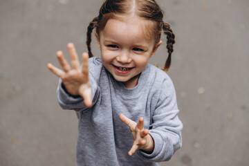 sincere children's laughter and fun, smiling girl playing and posing for a photo