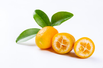 Top view of bunch of fresh kumquats in the organic food market. Some kumquats is cutted.