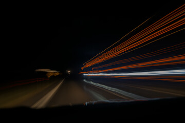 Abstract night road and velocity from a road trip, lights blur and shapes