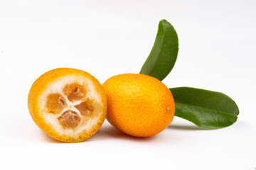 Top view of bunch of fresh kumquats in the organic food market. Some kumquats is cutted.
