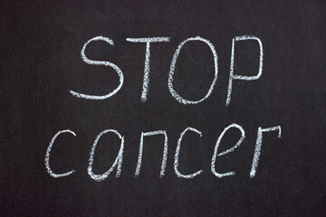Fototapeta premium The inscription on the chalk board stop cancer. A call to fight a serious illness