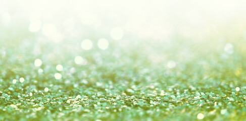 Defocus Abstract light blur blink sparkle horizontal backgound. Green glitter shine dots confetti.