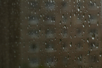 Many drops of water from the rain on the glass surface
