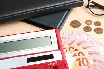 Calculator and money on wooden background, closeup. Tax accounting