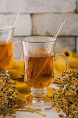 Glass of tea with autumnal decoration, vertical stock photo
