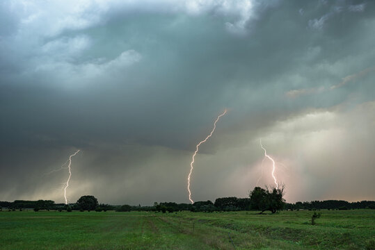 Several lightning bolts strike down from a severe thunderstorm in Hungary