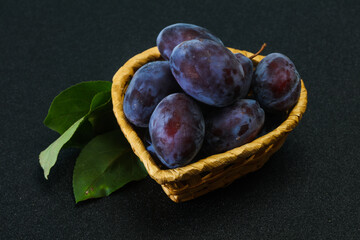 Ripe plum heap in the basket