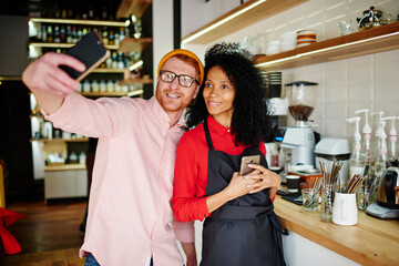 Joyful guy taking selfie relaxing with waitress