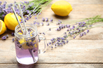 Fresh delicious lemonade with lavender in masson jar on wooden table. Space for text