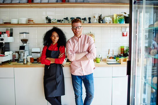 Handsome entrepreneur with colleague in coffee bar