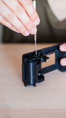 Woman's hands mounting a photo camera