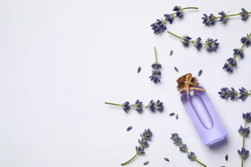 Poster Composition with lavender flowers and natural essential oil on white background, top view © New Africa