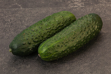 Green fresh cucumbers over background