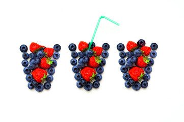 Conceptual food. Fresh berries in the form of glass on white isolated background. Close-up