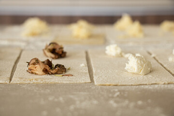 Close up of raw mushroom and cheese ravioli in the making