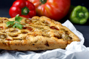 Traditional Italian focaccia with tomato and olives